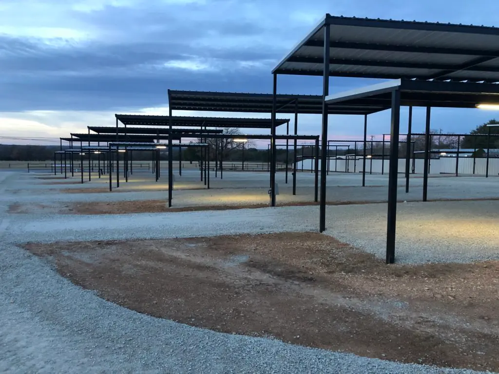 Covered sites at dusk, lit under the carports