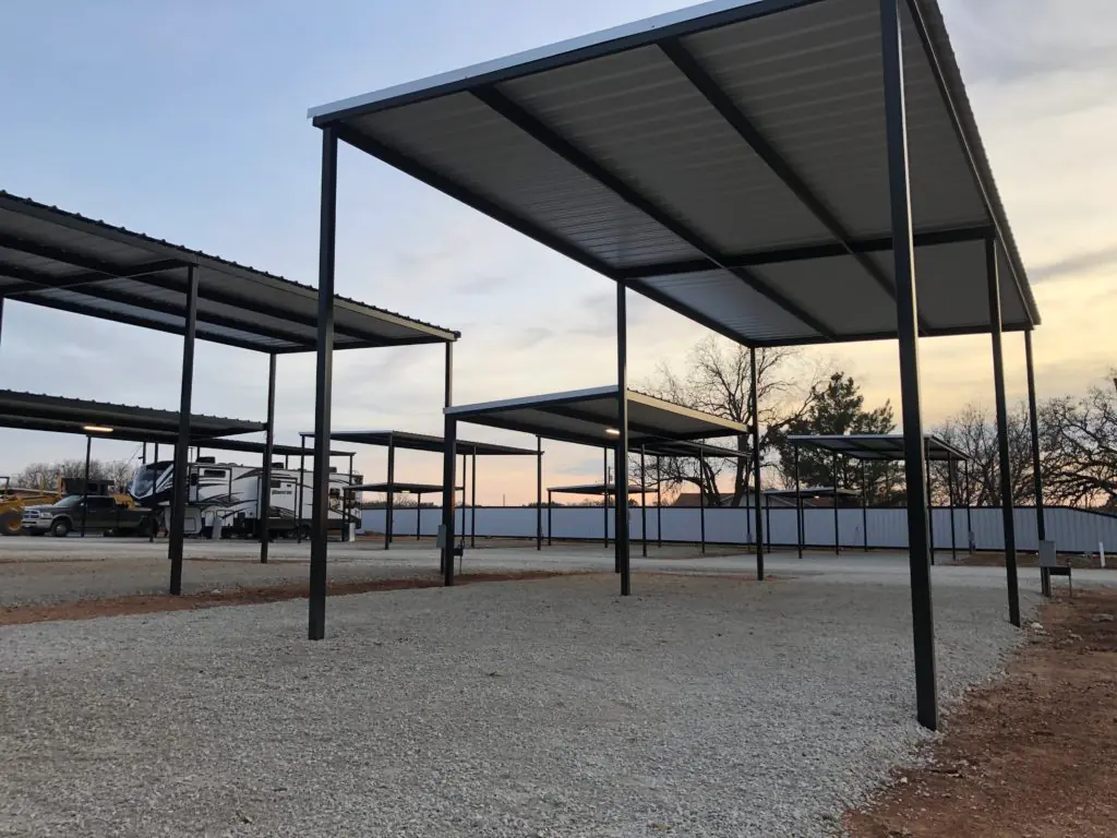 A covered site seen from the road at sunset